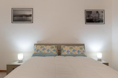 a bedroom with a bed with two pictures on the wall at Seaview in Salerno
