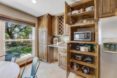 a kitchen with wooden cabinets and a table and chairs at Crested Oak in Cedar Park
