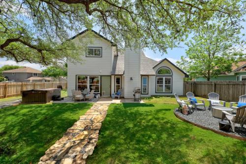 a house with a yard with chairs and a patio at Crested Oak in Cedar Park
