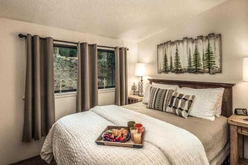 a bedroom with a bed with a tray of food on it at Peak In The Pines in Ruidoso