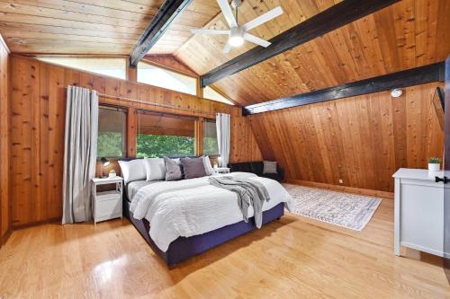 ein Schlafzimmer mit einem Bett in einem Zimmer mit Holzwänden in der Unterkunft Road Runner Lodge in Austin