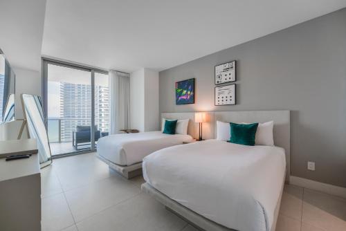 a hotel room with two beds and a large window at Beachside Condo with a Mesmerizing Ocean View in Hollywood