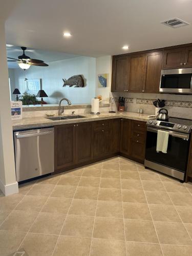 a kitchen with a sink and a stove top oven at Beacon Reef 306 in Islamorada