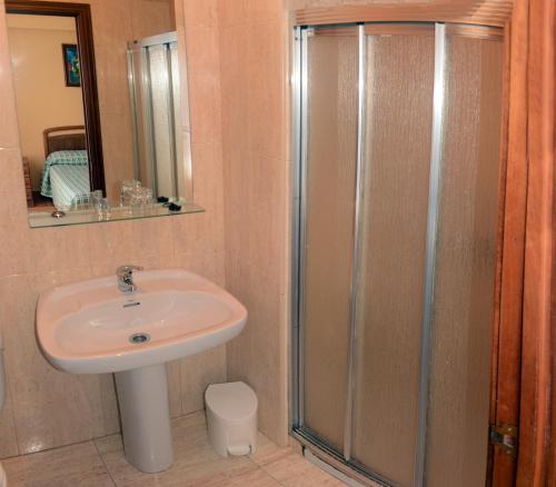 a bathroom with a sink and a shower at Hostal Baviera in Pesués
