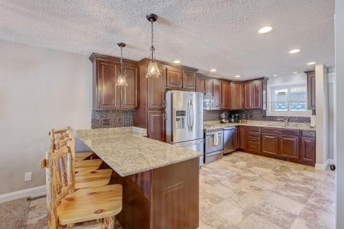 a kitchen with wooden cabinets and a counter top at Sunrise Beach for Family Fun and Walk to Noahs Ark in Wisconsin Dells