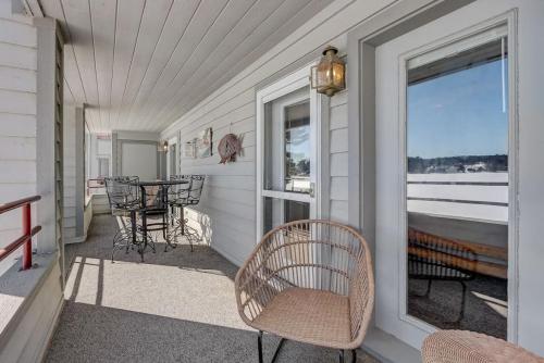 a porch with a table and chairs and a window at Sunrise Beach for Family Fun and Walk to Noahs Ark in Wisconsin Dells