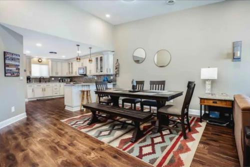 a kitchen and dining room with a table and chairs at LAKEFRONT PENTHOUSE FULLY UPGRADED PANORAMIC VIEWS BOAT SLIP INDOOR OUTDOOR POOL in Wisconsin Dells