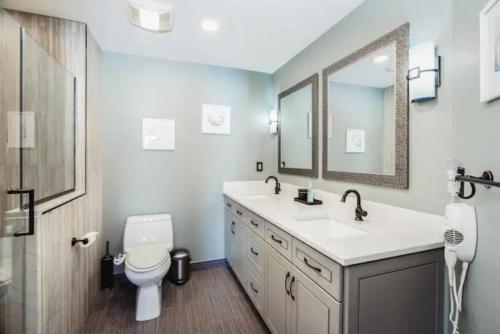 ein Badezimmer mit einem Waschbecken, einem WC und einem Spiegel in der Unterkunft LAKEFRONT PENTHOUSE FULLY UPGRADED PANORAMIC VIEWS BOAT SLIP INDOOR OUTDOOR POOL in Wisconsin Dells