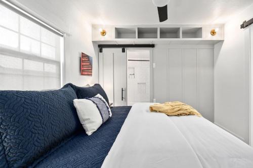 a bedroom with a large white bed and a window at Canterbury Cottage in Austin