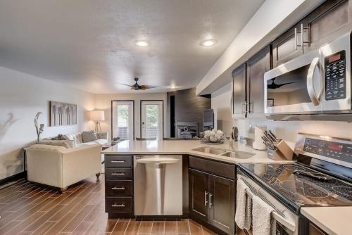 a kitchen with stainless steel appliances and a living room at Kates Place at Lighthouse Cove in Wisconsin Dells