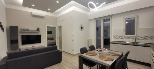 a living room with a couch and a table with chairs at Erre Home in Naples