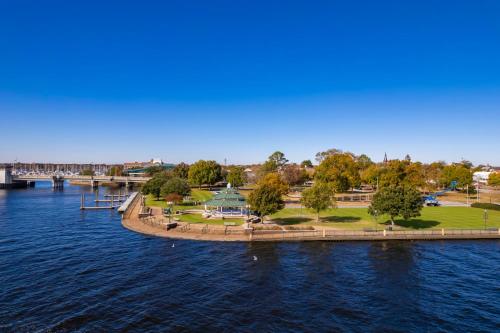 an island in the water next to a bridge at Higgins Downtown Depot in New Bern