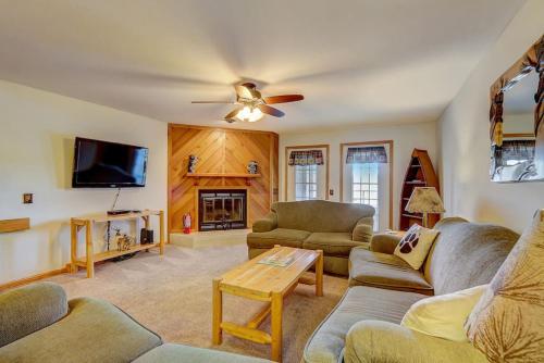 a living room with couches and a flat screen tv at Brown Family Condo for Families Golf Trips and Girls Getaways in Wisconsin Dells