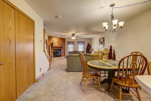 a dining room and living room with a table and chairs at Brown Family Condo for Families Golf Trips and Girls Getaways in Wisconsin Dells