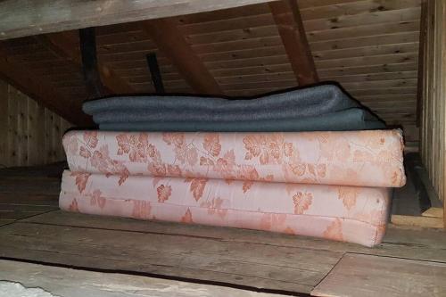 two blankets are stacked on top of each other at Almhütte für Summer und Wintersport in Pill