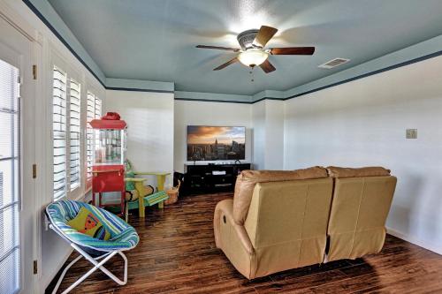 a living room with a ceiling fan and a couch at Lakeshore Haven in Spicewood