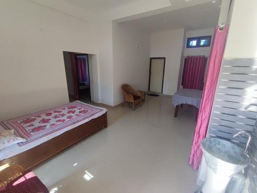 ein Schlafzimmer mit einem Bett und einem Stuhl darin in der Unterkunft Himanshu's place in North Lakhimpur
