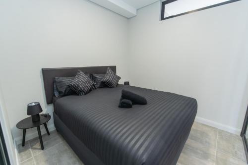 a bed with two pillows on it in a room at Bella Cabana Luxury Apartment in Summerstrand