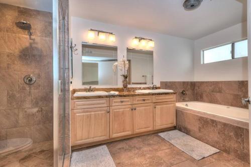 a bathroom with two sinks and a tub and a shower at Prime West Hollywood Designer Townhouse w Balcony in Los Angeles