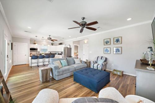 a living room with a couch and a ceiling fan at Coastal Hourglass in Port Bolivar