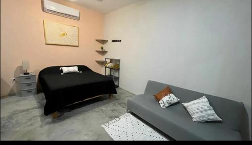 a living room with a couch and a bed at La Ventana Apartments Biznaga 2 in La Ventana