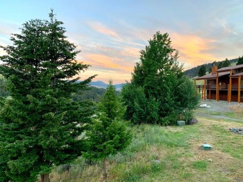 a group of trees in front of a house at Mammoth Overlook Of Yellowstone in Gardiner
