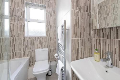 a bathroom with a white toilet and a sink at Two Bed House With Free Parking, near Train St. in Bath