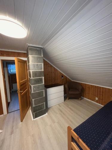 a room with a attic with a brick fireplace at Levi Piippo 2 in Kittilä