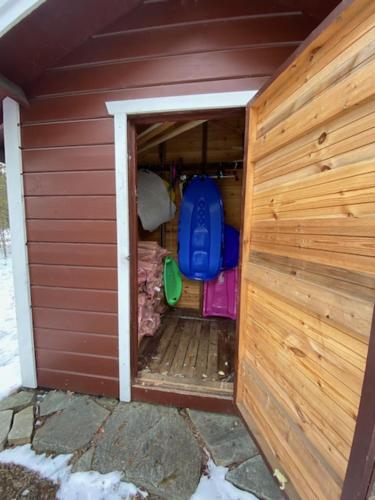 a small brown house with a door in it at Levi Piippo 2 in Kittilä