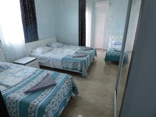 a room with two beds and a mirror at Hotel Georgia in Gonio