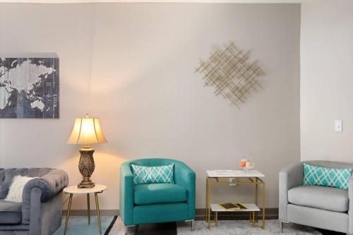 a living room with two chairs and a lamp at DT Charm Apt with Pool,Gym,Wine,WKSpace, Free Parking in Charlotte