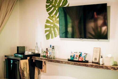 a counter in a hotel room with a mirror on the wall at Orchid House Tulum Jungle in Tulum