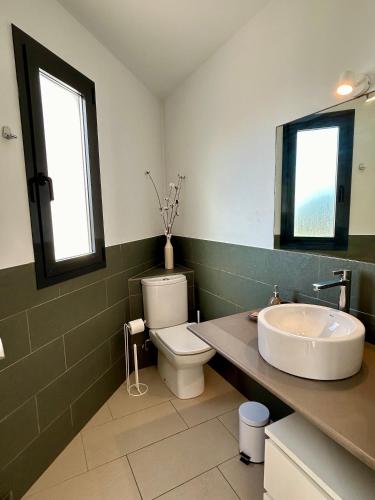 a bathroom with a sink and a toilet and a mirror at Villa Son Blanc 6 in Sa Caleta