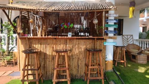 a bar with stools in front of a building at SOLS Backyard in Arambol