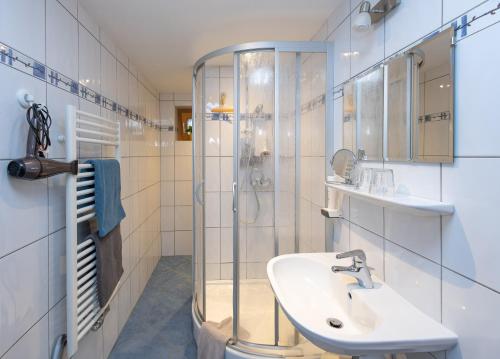 a bathroom with a sink and a shower at Appartement Schlosser in Zell am See