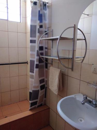 a bathroom with a sink and a shower at Apartamento Colca 's Home, cuenta con dos habitaciones in Chivay