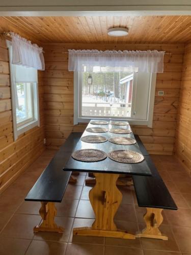 a dining room with a table in a cabin at Levi Piippo 2 in Kittilä