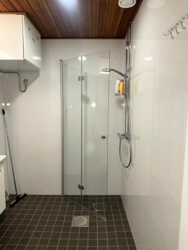 a shower with a glass door in a bathroom at Ade 1 in Oulu
