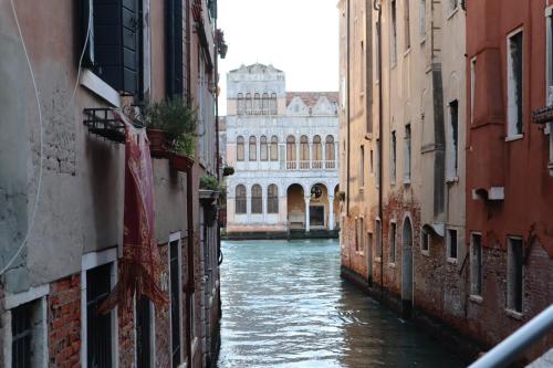 a view of a canal between two buildings at Ca' Piasentin in Venice