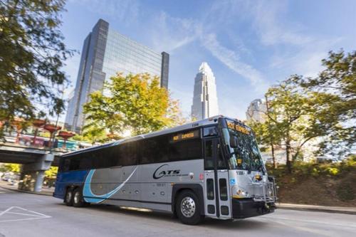 a bus driving down a street in a city at Uptown, Pool, Wine, Restaurants, BofA Stadium_307 in Charlotte