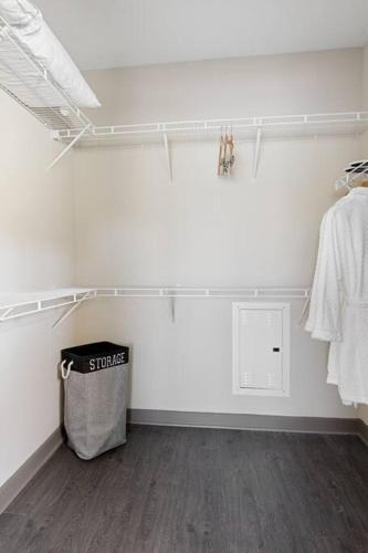 a white room with a trash can and a closet at Uptown, Pool, Wine, Restaurants, BofA Stadium_307 in Charlotte
