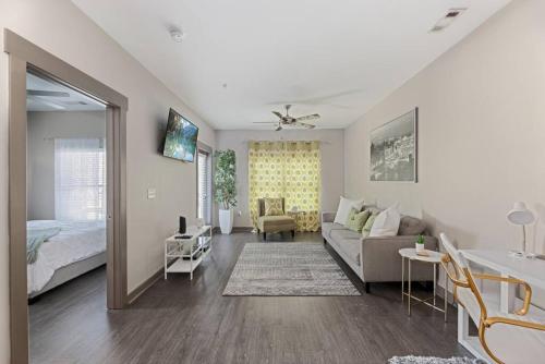 a living room with a couch and a bed at Uptown, Pool, Wine, Restaurants, BofA Stadium_307 in Charlotte