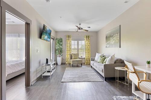 a living room with a couch and a bed at Uptown, Pool, Wine, Restaurants, BofA Stadium_307 in Charlotte