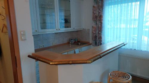a kitchen counter with a sink and a cabinet at Pension Britta in Roetgen