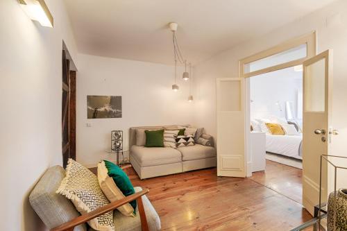 a living room with a couch and a bed at Romantic Gem in Santos in Lisbon