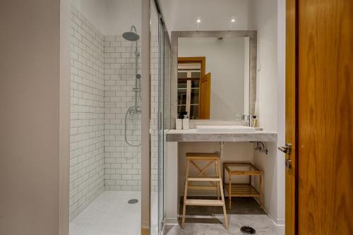 a bathroom with a sink and a shower with a mirror at Master Historical Gem in Chiado in Lisbon