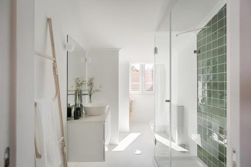 a white bathroom with a shower and a sink at Romantic Gem in Graça in Lisbon