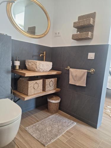 a bathroom with a sink and a mirror at Au Jardin d'Armand in Sant Pere de Ribes