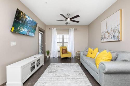 a living room with a couch and a ceiling fan at 1Br Uptown, Pool, Wine, near Convention Center_311 in Charlotte