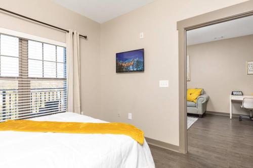 a bedroom with a bed and a large window at 1Br Uptown, Pool, Wine, near Convention Center_311 in Charlotte